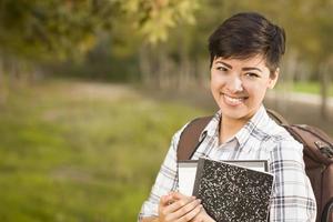 Portrait of a Pretty Mixed Race Female Student Holding Books photo