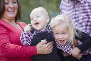 Mommy and Daddy Having Fun with Baby Brother And Sister photo