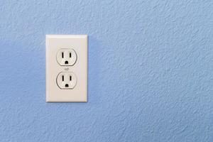 Electrical Sockets In Colorful Blue Wall photo