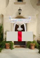 Drone Delivering Red Ribbon Wrapped Package to House Porch photo