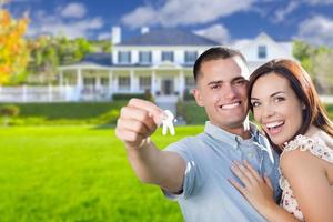 Military Couple with House Keys In Front of New Home photo