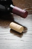 Wine Bottle and Cork on a Reflective Wood Surface Abstract. photo