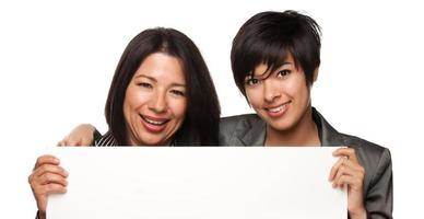 Attractive Multiethnic Mother and Daughters Holding Blank White Sign photo