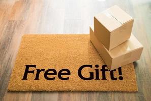 Free Gift Welcome Mat On Wood Floor With Shipment of Boxes photo