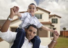 Hispanic Father and Son in Front of House photo