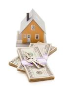 Home and House Keys on Stack of Money Isolated photo