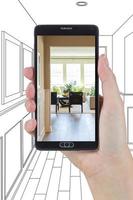 Hand Holding Smart Phone Displaying Photo of House Hallway Drawing Behind