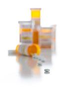 Frascos de prescripción de medicamentos no patentados y píldoras derramadas aisladas en blanco foto