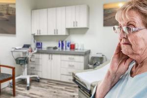 Worried Senior Adult Woman Waiting in Doctor Office photo