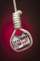 House Tied Up and Hanging in Hangman's Noose on Red photo