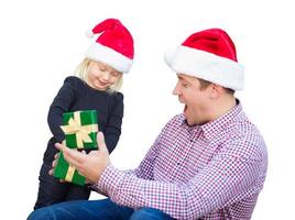 Happy Young Girl and Father Wearing Santa Hats Opening Gift Box Isolated on White. photo