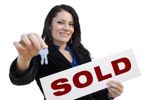 Hispanic Woman Holding Sold Sign and Keys On White photo