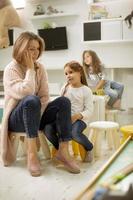 Nursery teacher talking to little girl with a problem in the kindergarten photo