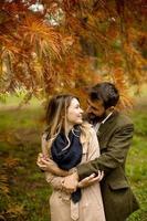 Young couple in the autumn park photo