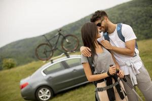 Couple of hikers with backpacks starting a walk through the fields photo