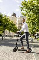 Young African American using electric scooter on a street photo