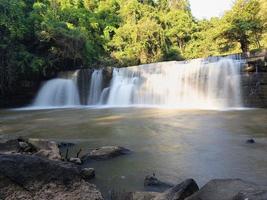 Front view, Sri Dit Waterfall is a small and forested one level waterfall with sunlight at Khao Kho, Phetchabun Province, Thailand. photo