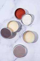 colorful lip balms in round tin cases with shadow overlay, mockup design photo