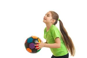 little girl plays with a soccer ball photo