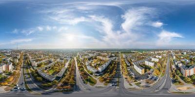 aerial full seamless spherical hdri 360 panorama view above road junction with traffic in city overlooking of residential area of high-rise buildings in equirectangular projection. photo