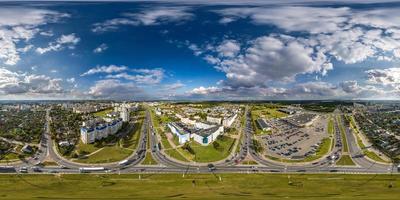 aerial full seamless spherical hdri 360 panorama view above road junction with traffic in city overlooking of residential area of high-rise buildings in equirectangular projection. photo