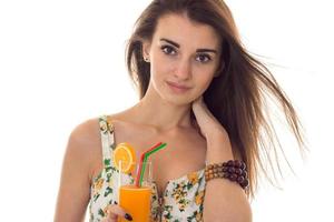 pretty lady in sarafan with floral pattern looking at the camera and drinks orange cocktail isolated on white background photo