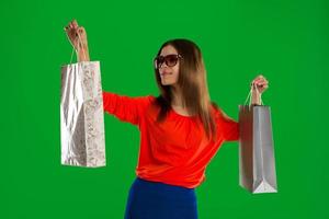 woman in glasses and with bags in hands photo