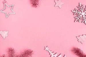 Christmas background. Frame of decorations and fir tree twigs in color 2023 Viva Magenta Copy space photo