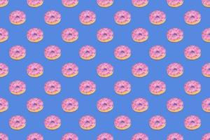 Fashionable seamless pattern of traditional doughnuts with lilac glaze on trendy classic blue background. Top view. photo