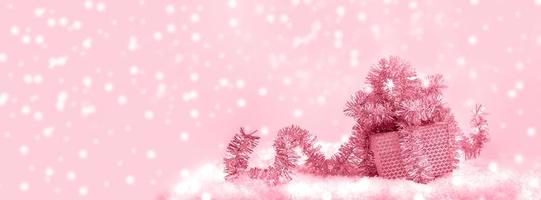 Festive Christmas banner. Gift box with shiny tinsel on snowy background. Toning in Viva Magenta. photo