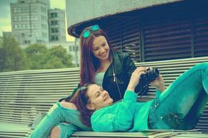 Girls resting on a bench photo