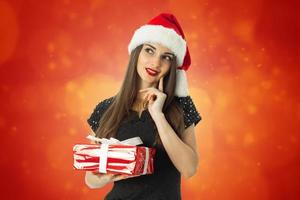 gorgeous brunette woman in santa hat photo