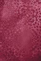 Decorative pattern on textured holographic paper toning in color of 2023 Viva Magenta. Selective focus. photo