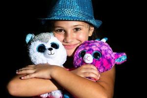 A little girl with two soft toys photo