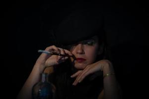 Retro woman with mouthpiece cigarette and alcohol. retro style photo