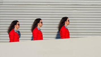 Threefold girl walks between a wall and sheet photo