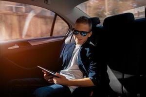 cheerful young boy in sunglasses photo