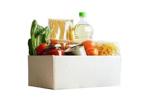 Foodstuffs in donation box isolated on white background with clipping path for volunteer to help people. photo