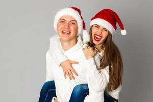 couple in love celebrates christmas in santa hat photo