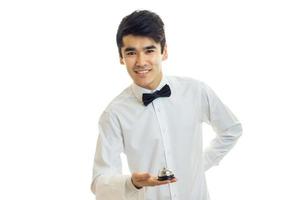 young waiter looks straight and smiling isolated on white background photo