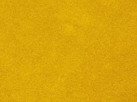 yellow velvet fabric texture used as background. Empty yellow  fabric background of soft and smooth textile material. There is space for text photo