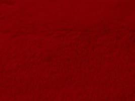 red clean wool texture background. light natural sheep wool.red seamless cotton. texture of fluffy fur for designers. close-up fragment white wool carpet.. photo