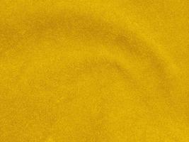 yellow velvet fabric texture used as background. Empty yellow  fabric background of soft and smooth textile material. There is space for text photo