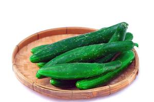 Japanese cucumbers placed in bamboo basket are popular to eat fresh. And used for cooking, such as stir-frying, boiling, pickling, steaming, or juiced as a drink or used to decorate the dish. photo