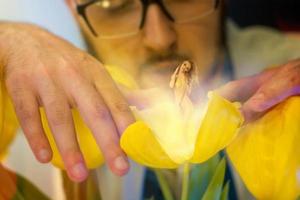 handsome young scientist in glasses grew a sexy girl in flower photo