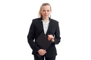 beautiful young blonde business stands in the black suit holding a paper and smiling photo