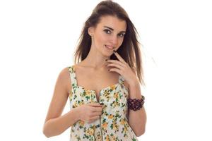 adorable young brunette woman take off her sarafan with floral pattern and seduce on camera isolated on white background photo