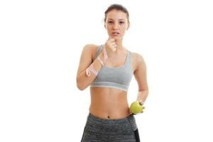 beautiful young girl thoughtfully looks ahead and holding a Green Apple photo