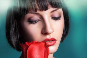 Horizontal portrait of cutie brunette with red rose photo