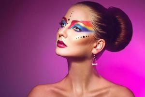 Horizotnal portrait of attractive woman with multicolor make up on purple backgorund photo